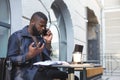 African american bussines man having a heated arguement with colleague over the phone Royalty Free Stock Photo
