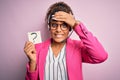 African american call center agent girl working using headset holding question mark symbol stressed with hand on head, shocked Royalty Free Stock Photo