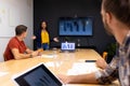 African american casual businesswoman giving presentation to diverse colleagues in meeting room Royalty Free Stock Photo