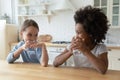 African American and Caucasian cute little girls drinking pure water Royalty Free Stock Photo