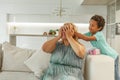 African American child boy holding his mother closed eyes. Happy mother`s day Royalty Free Stock Photo