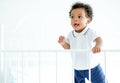 African American child boy stand near bed rail and he look happy by smiling and show teeth and look innocent. Concept of happiness Royalty Free Stock Photo