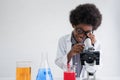 African american child boy student is learning and test science chemical by looking to microscope in laboratory Royalty Free Stock Photo