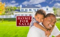 African American Child with Father In Front of Sale Sign and House Royalty Free Stock Photo