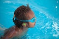 African American child with goggles in the pool Royalty Free Stock Photo