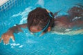 African American child with goggles in the pool