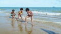 African American children play tug-of-war on the beach,Summer theme