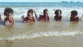 African-American children Playing the sea waves on the beach merrily on a summer holiday