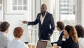 African american coach talking to audience giving presentation on flipchart Royalty Free Stock Photo