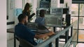African american coder writing programming language on computer Royalty Free Stock Photo