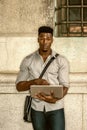 Young black man working on laptop computer on street in New York City Royalty Free Stock Photo