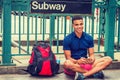 Young man texting on cell phone on street, traveling in New York City Royalty Free Stock Photo