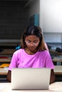 African american college student using laptop in class. Teen female black high school student doing homework. Vertical. Royalty Free Stock Photo