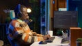 African american computer scientist in home office programming code on pc
