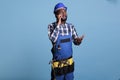 Builder talking on smart phone wearing coverall Royalty Free Stock Photo
