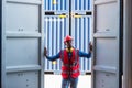 African American Container Warehouse Worker. Foreman control loading Containers box from Cargo freight ship for import export.