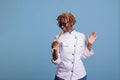 African american cook portrait singing with kitchen utensil