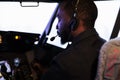 African american copilot flying airplane in cockpit with captain Royalty Free Stock Photo