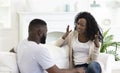 African american couple arguing at home, woman blaming her husband. Royalty Free Stock Photo