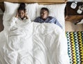 African American couple on bed, man snoring and disrupting woman