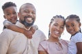 African american couple carrying their little kids outside. Adorable little brother and sister enjoying free time with Royalty Free Stock Photo