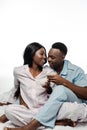 African american couple drinking coffee in bed in pajamas  on white Royalty Free Stock Photo