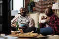 African american couple eating takeaway meal with noodles and chips Royalty Free Stock Photo