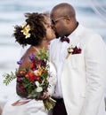 African American couple getting married at the beach