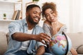 African-american couple with globe choosing place for travel