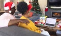 African american couple having face time and using laptop with copy space Royalty Free Stock Photo