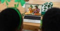 African american couple having st patrick\'s day video call with male friends on laptop at home