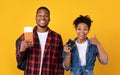 African American Couple Holding Flight Tickets And Camera, Yellow Background Royalty Free Stock Photo