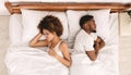 African-american couple ignoring each other in bed Royalty Free Stock Photo