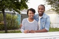 African American couple look to camera outside their house Royalty Free Stock Photo