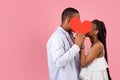 Young Romantic Black Couple Kissing Hiding Behind Red Paper Heart Royalty Free Stock Photo