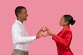 African american couple in love making heart shape with hands
