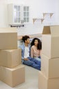 African American couple moving new home. man, woman are sitting among boxes talking mortgage Royalty Free Stock Photo