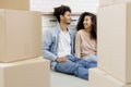 African American couple moving new home. man, woman are sitting among boxes talking mortgage Royalty Free Stock Photo