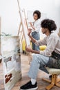 African american couple painting on easels