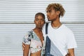 African american couple posing by a wall