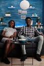 African american couple with pregnancy watching television Royalty Free Stock Photo