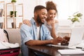 African-American Couple Searching Tour Online On Laptop Royalty Free Stock Photo