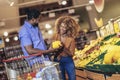 African american couple shopping for healthy fresh food at produce section of supermarket Royalty Free Stock Photo