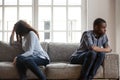 African American couple sitting separately after quarrel