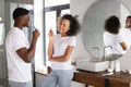 African American Couple Smiling While Brushing Teeth In Modern Bathroom Royalty Free Stock Photo