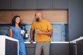 African American Couple Talking And Drinking Coffee In Kitchen At Home Royalty Free Stock Photo
