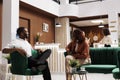 African american couple talking in lobby Royalty Free Stock Photo