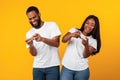 African american couple using cellphones, playing game Royalty Free Stock Photo