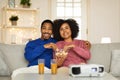 African American Couple Watching Movie Via Projector Eating Popcorn Indoors Royalty Free Stock Photo