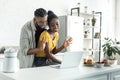 african american couple waving hands during video call